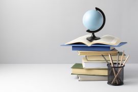 front-view-stacked-books-earth-globe-open-book-pencils-education-day